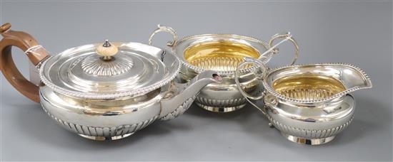 A matched silver three-piece tea service of flattened circular half-fluted form Total approx 44oz